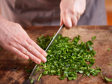 Cross-Chop knife chopping grip - easy and safe technique for easily chopping herbs and vegetables into fine pieces with a simple knife rocking method