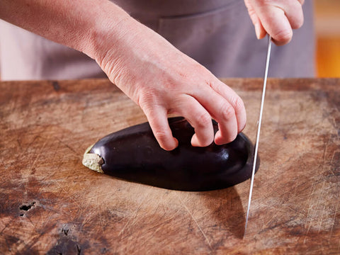 The Claw Grip knife cutting technique - one of the most famous and frequently used knife grips for slicing and chopping food or vegetables into slices or fine pieces