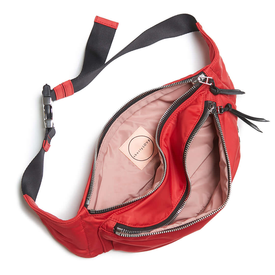 a red arcade crossbody belt bag