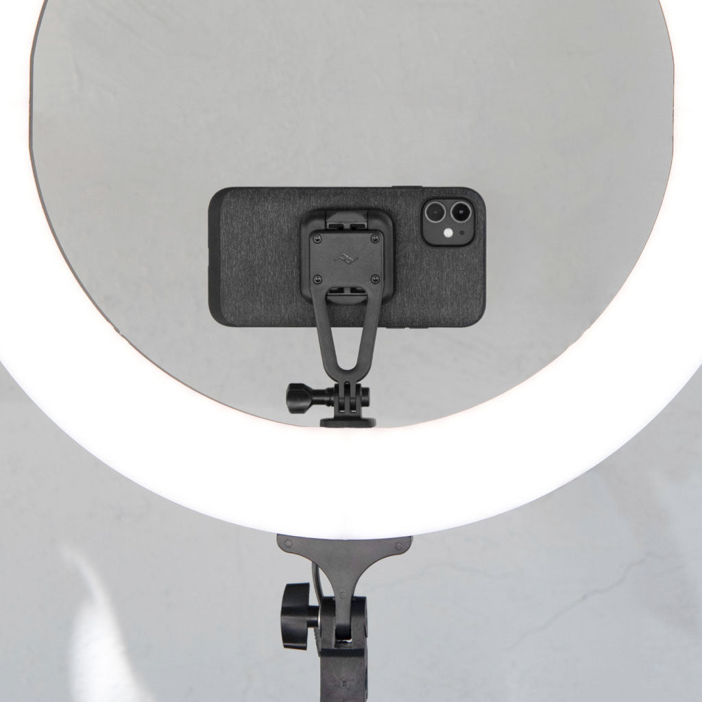 An iPhone with Everyday Case mounted on a Creator Kit with a ring light attached to it