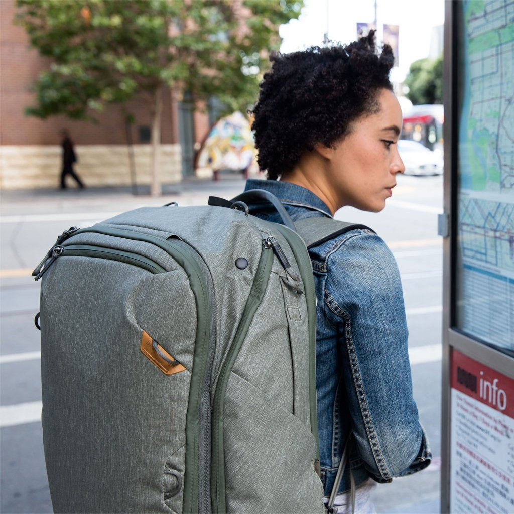 Anne wearing the sage travel bag