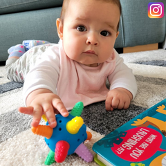 baby on floot with teether ball