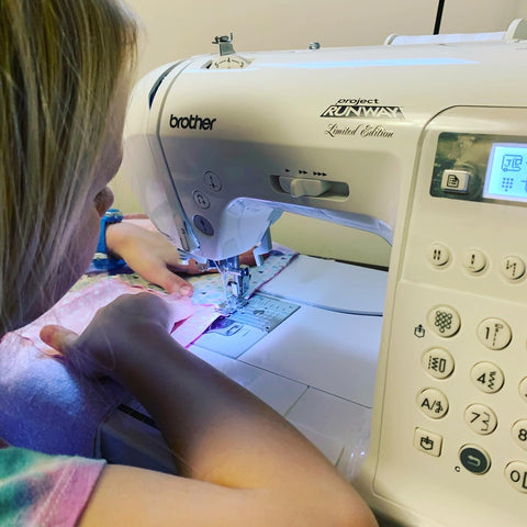 Daughter using the sewing machine