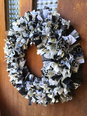 Black and white scrap fabric wreath hanging on the door