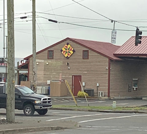 Barn Quilt on a brown building far away