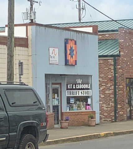 Barn quilt hanging outside a thrift store