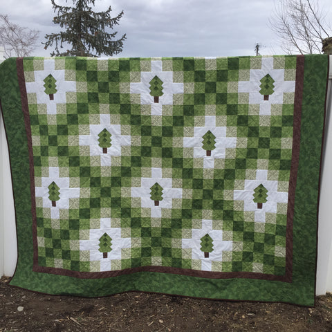 Irish Woodland Quilt hanging on a fence