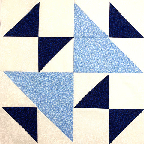 Triangle Weave Quilt Block in Dark blue and light blue with a white background