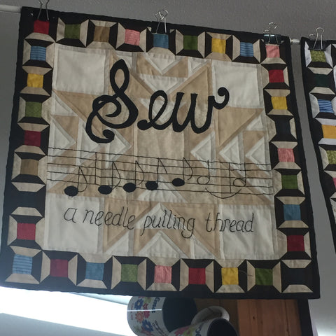 Sew, a Needle Pulling Thread Wall Hanging