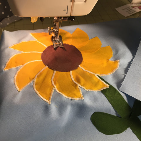 Appliqué the pieces of the sunflower into place. 