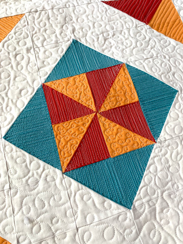 Close up on the quilting of the All Seasons Squares Quilt in red