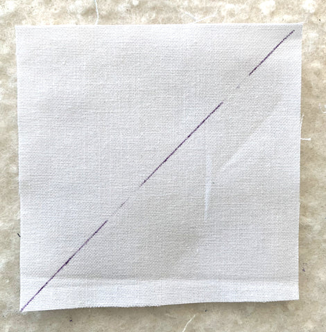 Line drawn on white fabric square