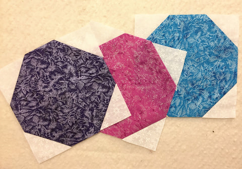 Three circle blocks in purple, pink, and teal