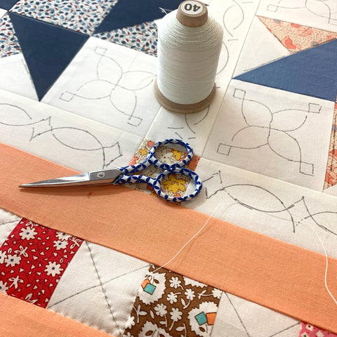 Quilt with scissors and thread