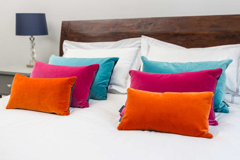 velvet orange cushions with velvet turquoise cushions and velvet pink cushions