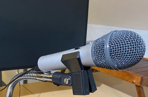 Microphone supported by mic clip attached to flexible gooseneck arm