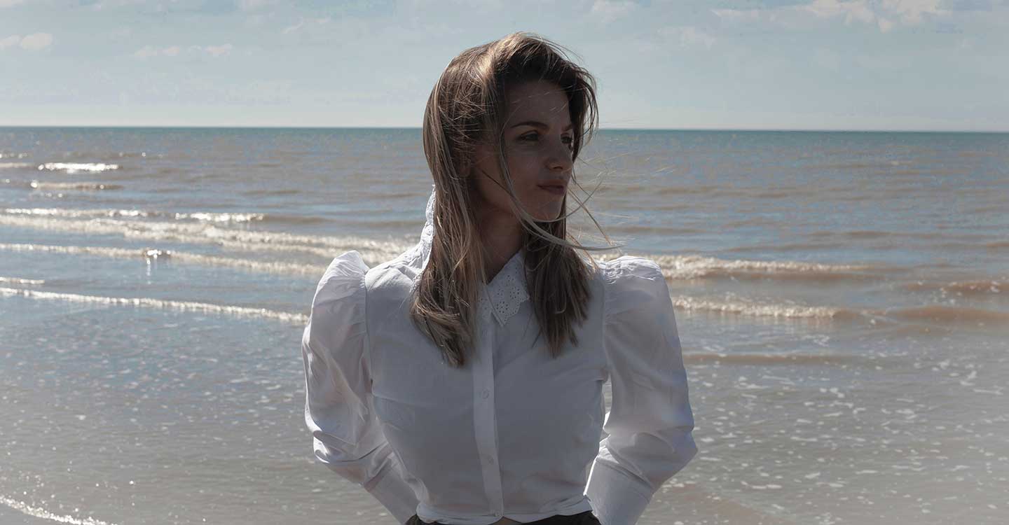 kiya on the beach wearing white cotton embroidered shirt