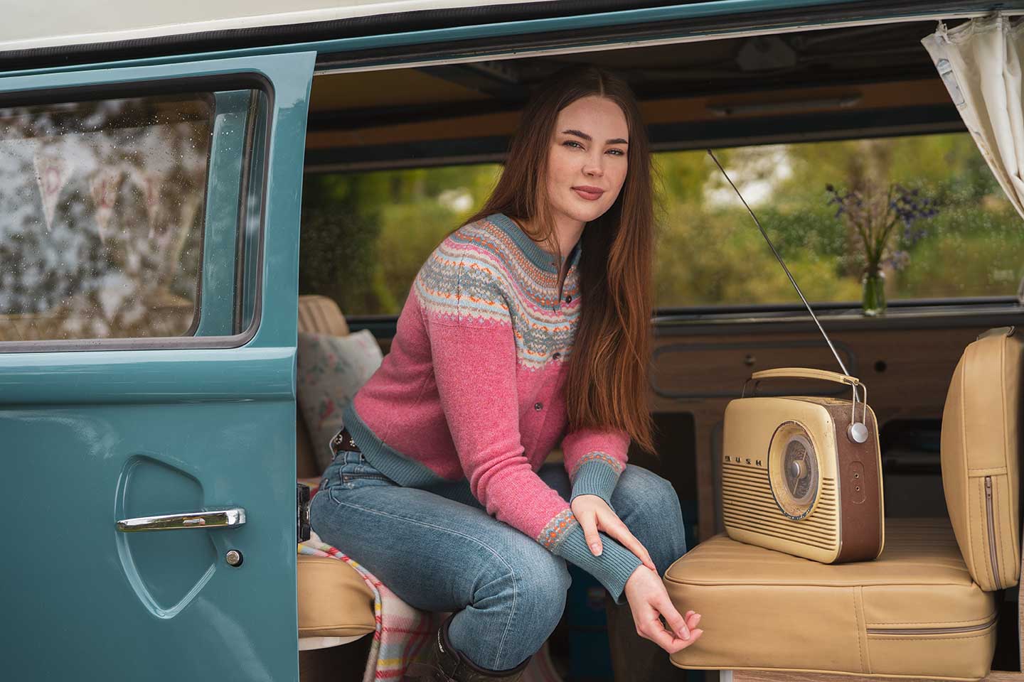 nougat short alpine merino cardigan sat in camper van on holiday