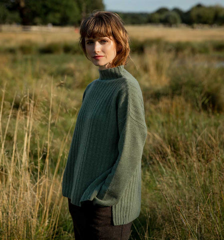 Woman wearing green oversized cashmere jumper