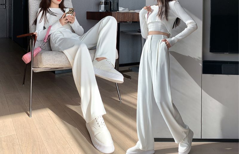 Stylish white outfits with wide-leg pants, modern room background