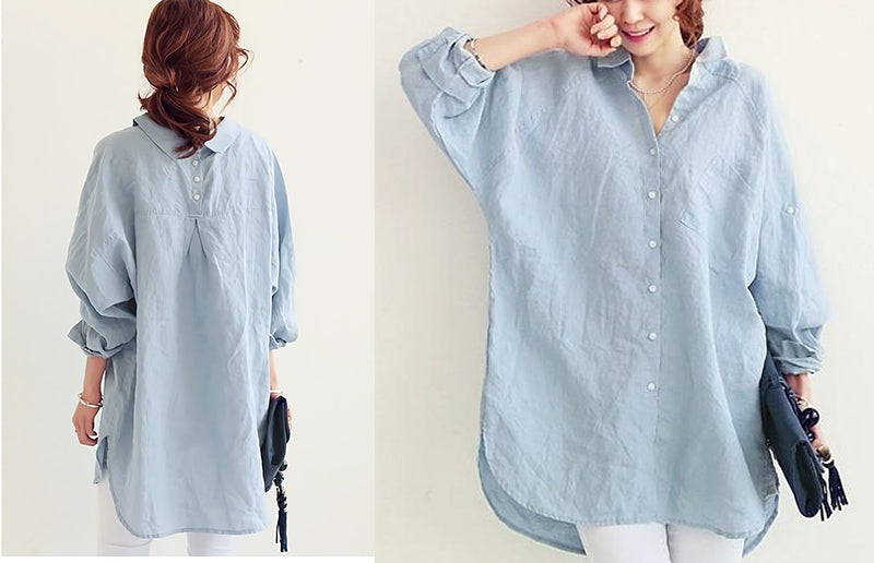 Model showcasing light blue oversized linen shirt with rolled-up sleeves.