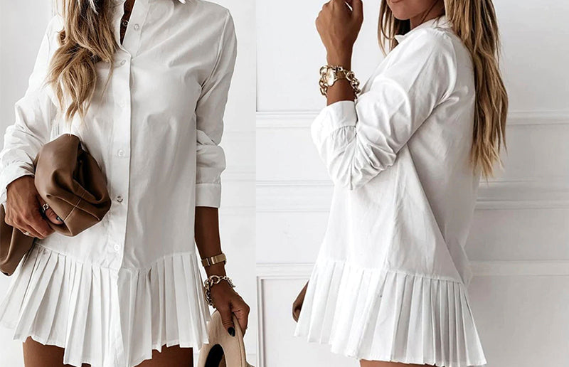 White pleated shirt-dress, accessorized with brown hat and white shoes.