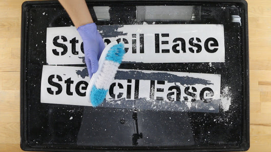 Cleaning Parking Lot Stencils with a Brush