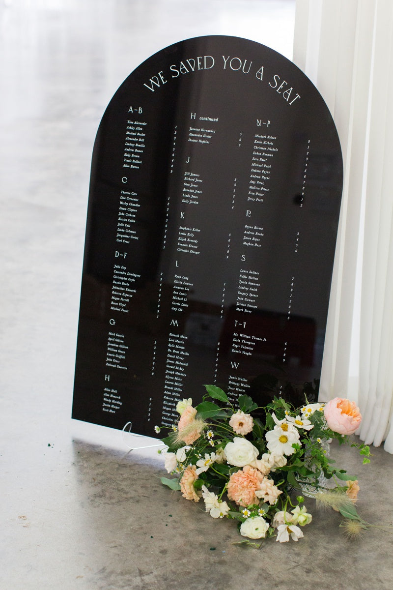 Arched black wedding seating chart sign by Lily & Roe Co.