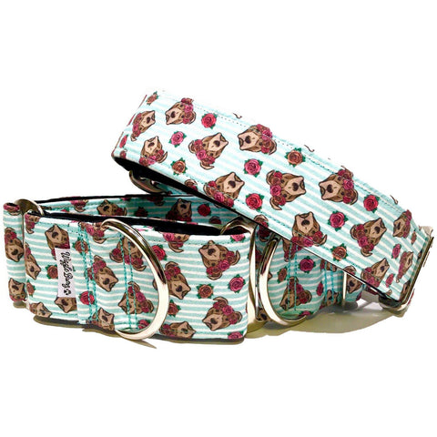 a dog collar featuring busts of pitbulls wearing crowns on a light blue striped background
