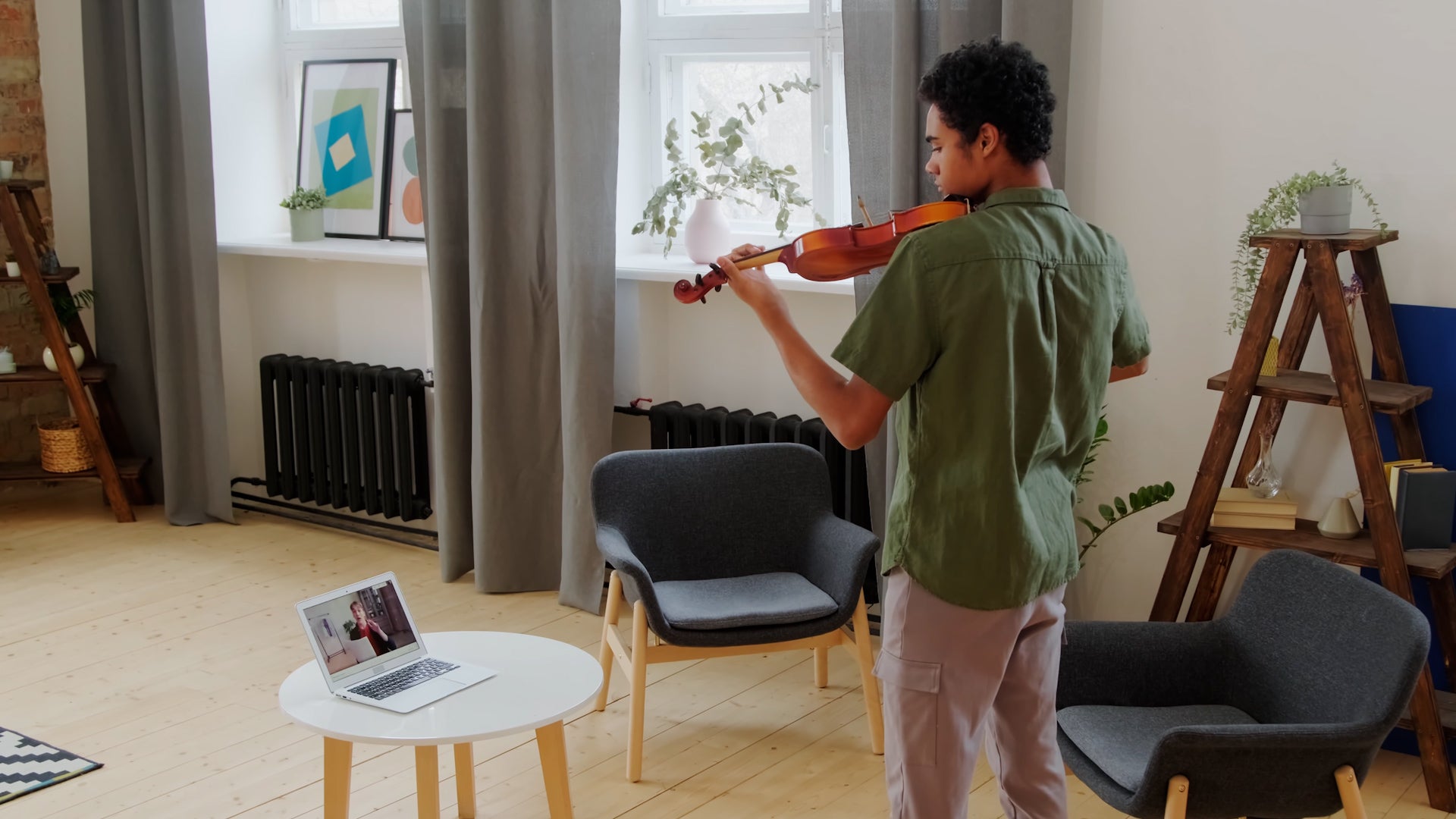 man playing violin with a teacher