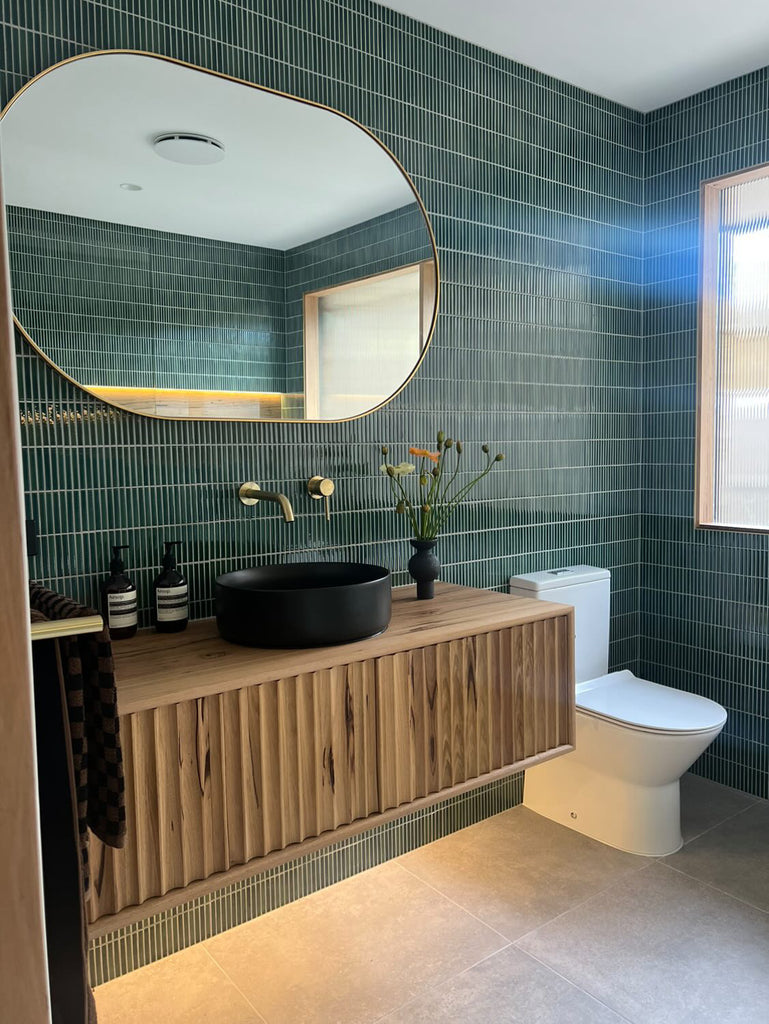 Bold green tiled bathroom