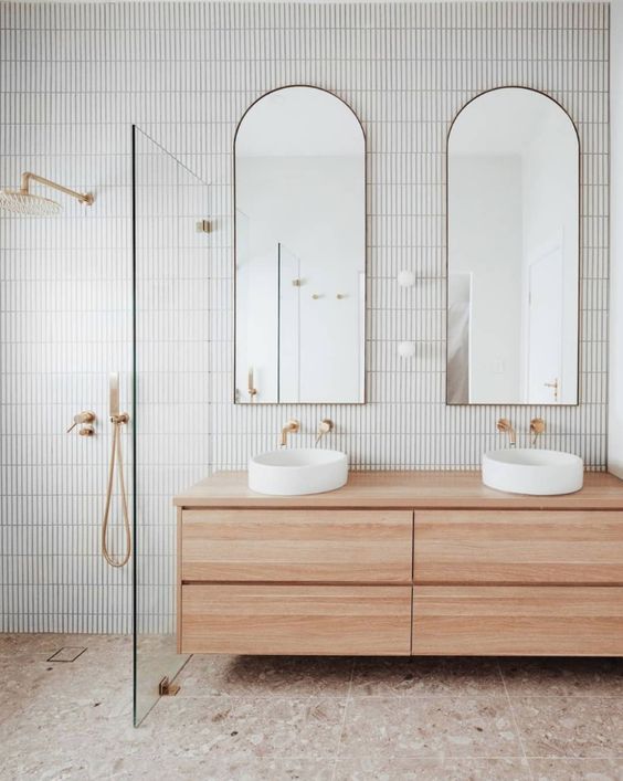 Double sinks and mirrors in a bathroom.