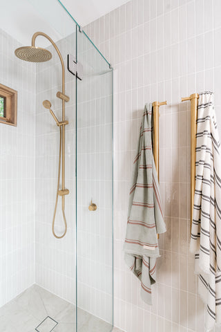 coastal bathroom with brushed brass tapware