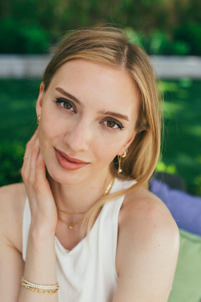 woman wearing bracelets, necklaces and earrings