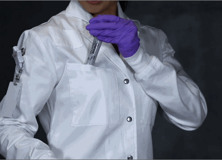 female scientist putting tweezers and markers in lab coat pocket
