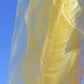 Close Up of Delicate Yellow Silk Stole against the Blue Sky