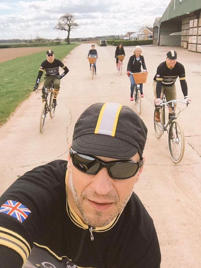 A seflie photo of a group of Pashley Guv'nor Assembly riders cycling together next to a farm building.