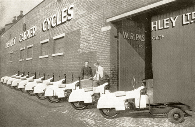 Old photo of the original Pashley Factory in Birmingham with motorised cargo trucks lined up outside.