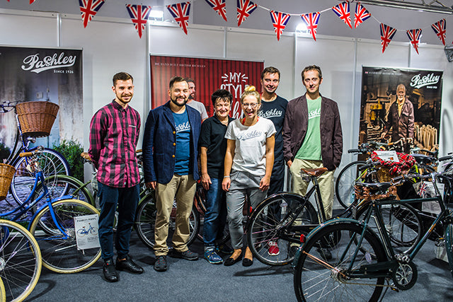 The urban life team wearing Pashley t-shirts whilst standing below union jack bunting and surround by Pashley bikes.