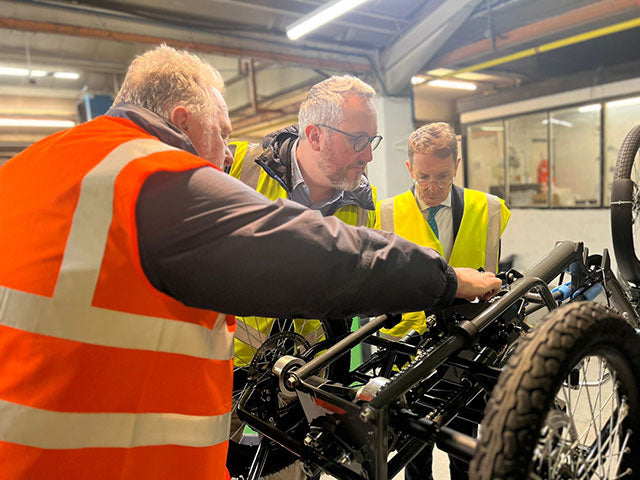 Andy Street looking at e-trike in the Pashley factory with Steven Bell and Adam Tranter.