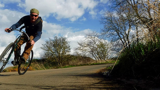 Bike rider cornering at speed on his Pashley SPEED 5 bicycle on a country lane.
