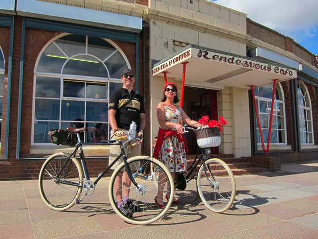 A lady and gent with their Pashley bicycles outside the Rendezvous Cafe.