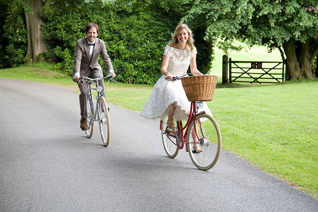 The happy couple riding a Pashley Phantom and Pashley Britannia bicycle on their wedding day.