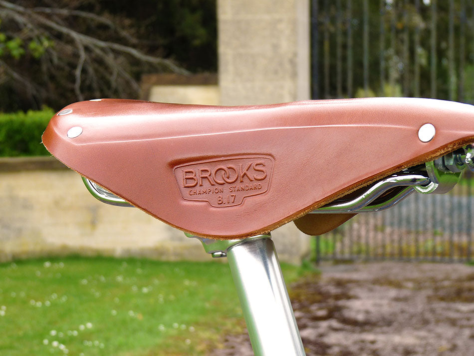 A close-up of the honey brown brooks B17 leather saddle on the Kingsman bicycle.