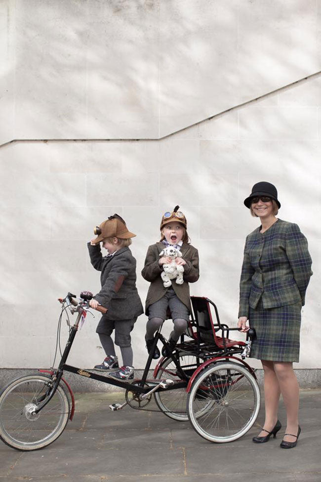 A Pashley Picabac tricycle with children and their mum all dressed in tweed.