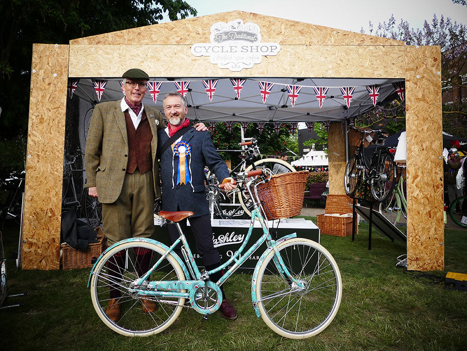 Adrian Williams presenting a blue printed Pashley bicycle to the winner at the Tweed Run party.