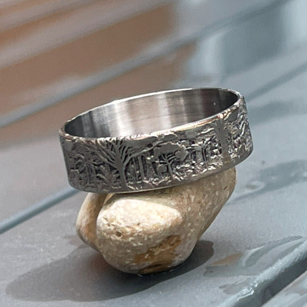 Forest engraving on a titanium beauty ring