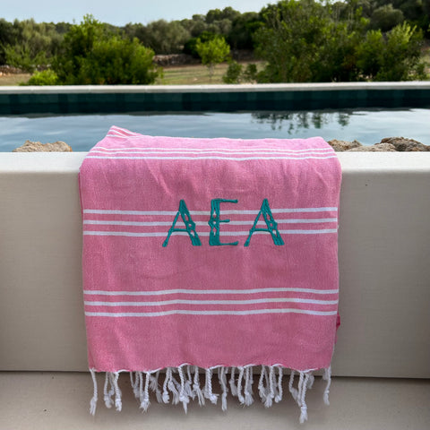 pink Turkish towel with an embroidered monogram