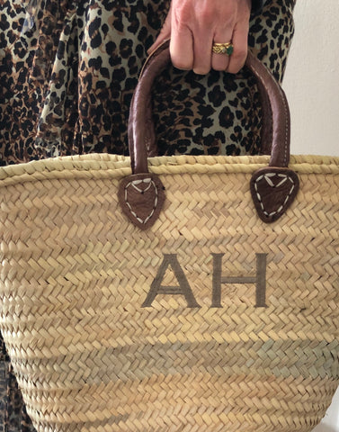 handwoven moroccan palm leaf basket with embroidered initials