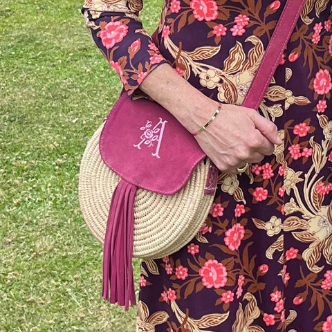 Rattan and suede cross body bag with an embroidered monogram